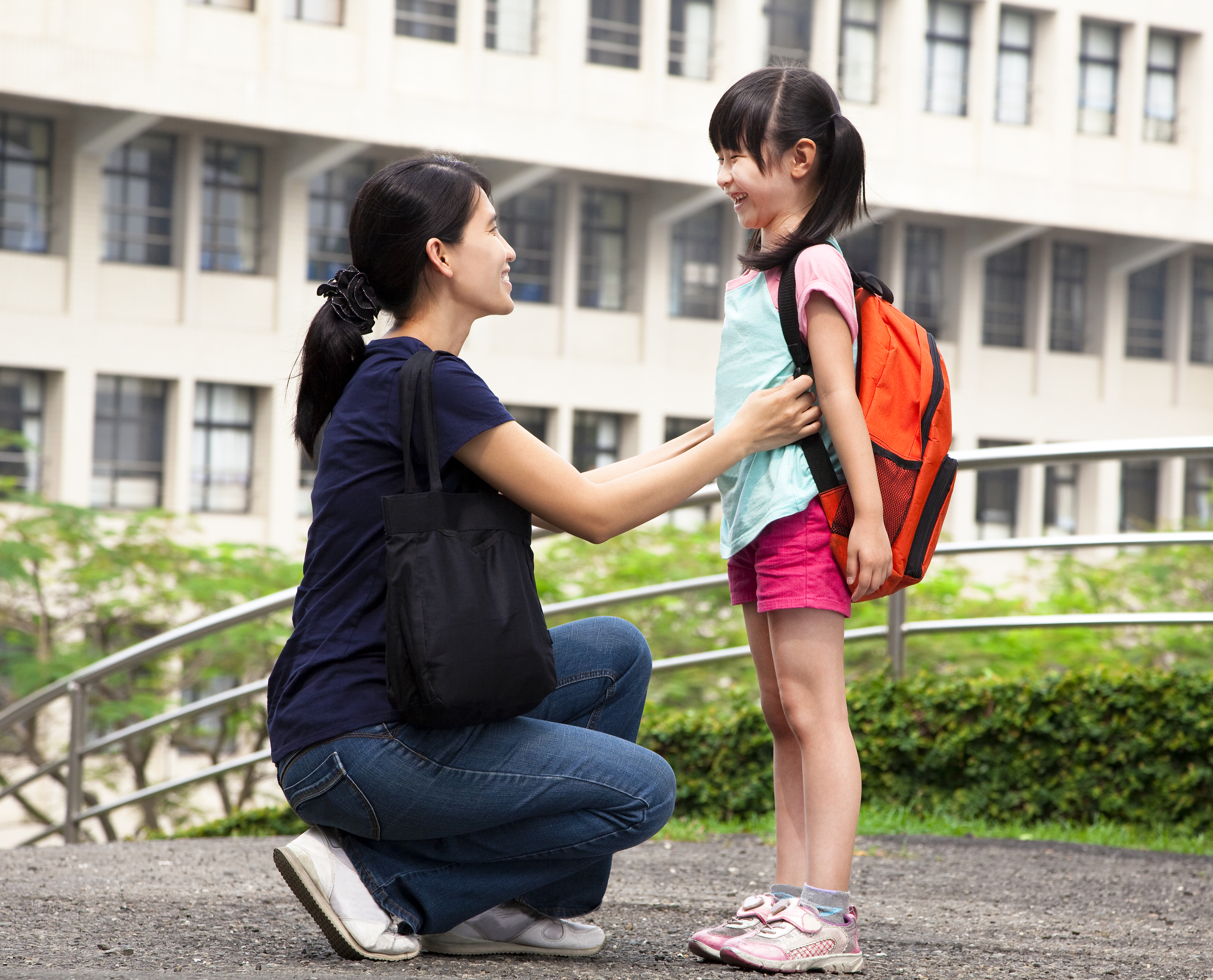 back to school.happy asian mother with daughter in school