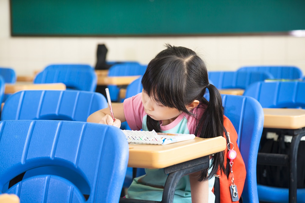 school girl study alone in the classroom