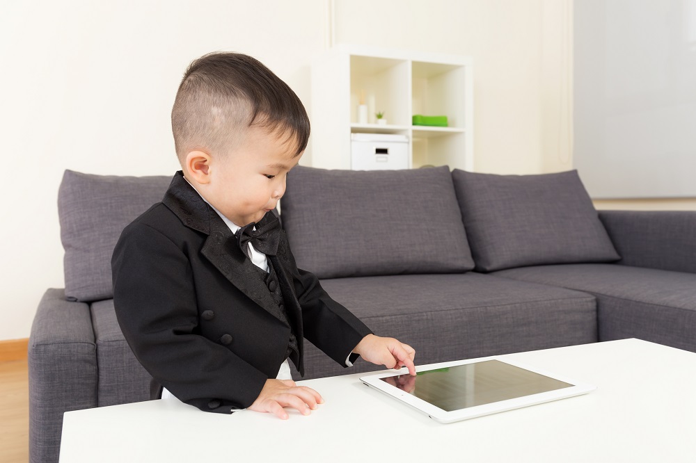 Little boy using tablet at home