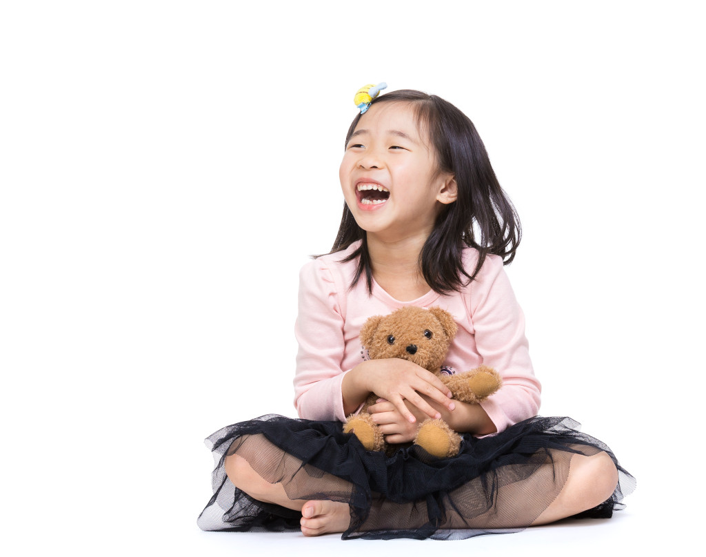 Asia little girl with doll bear